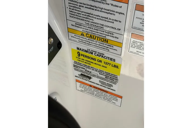Slide: The Image of 2025 Bayliner Element E18 capacity label, max 9 persons or 1277 lbs, safety warnings visible. - 17