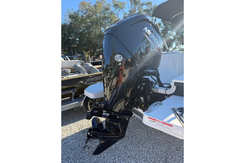 Slide: The Image of 2025 Bayliner Element E18 with Mercury outboard motor, parked on gravel. - 9