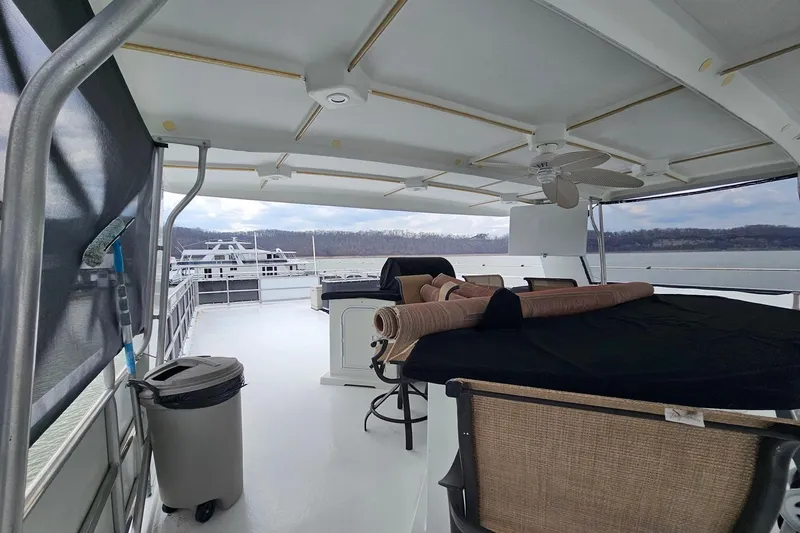 Slide: The Image of Covered deck of 2002 Sharpe 18x85 houseboat with seating and scenic lake view. - 10