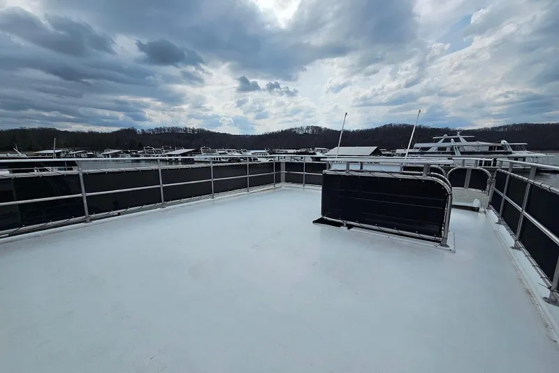 Slide: The Image of Rooftop deck of 2002 Sharpe 18x85 houseboat under cloudy sky. - 14