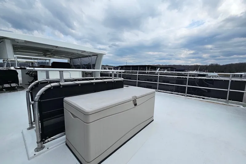 Slide: The Image of Rooftop deck of 2002 Sharpe 18x85 houseboat with storage box, under cloudy sky. - 17