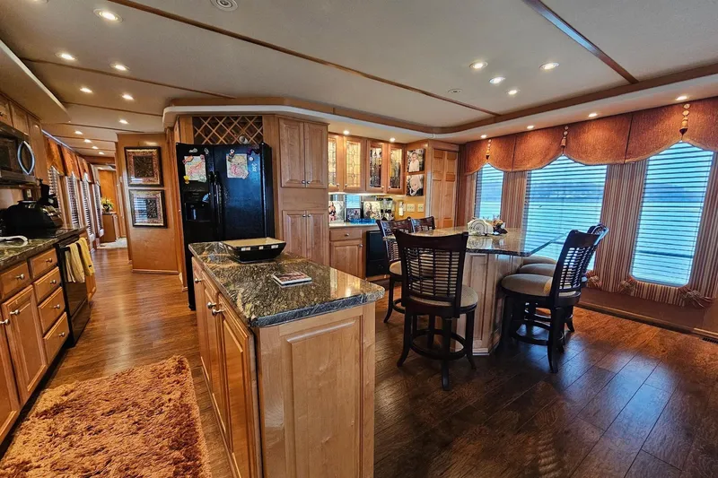 Slide: The Image of Luxurious kitchen interior of 2002 Sharpe 18x85 houseboat with wooden cabinetry and granite countertops. - 24