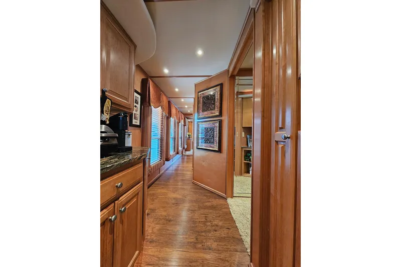 Slide: The Image of Luxurious wooden interior of 2002 Sharpe 18x85 houseboat with elegant decor and lighting. - 28