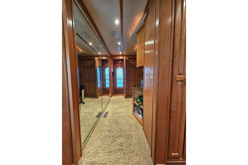 Slide: The Image of Luxurious interior of 2002 Sharpe 18x85 houseboat with wood paneling and mirrored closet. - 29