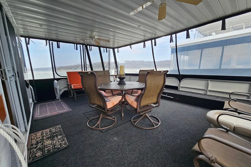Slide: The Image of Spacious 2002 Sharpe 18x85 houseboat interior with seating and ceiling fans. - 3