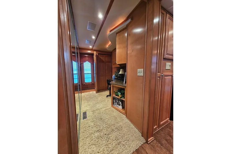 Slide: The Image of Luxurious interior of 2002 Sharpe 18x85 houseboat with wood paneling and plush carpet. - 30