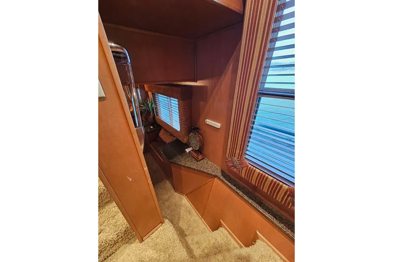 Slide: The Image of Interior of 2002 Sharpe 18x85 houseboat with wooden decor and window blinds. - 35