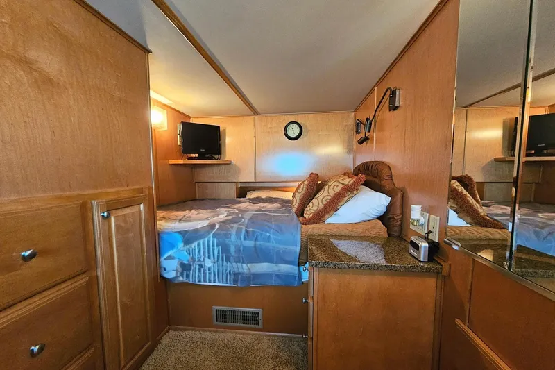 Slide: The Image of Cozy bedroom in 2002 Sharpe 18x85 houseboat with wood paneling and TV. - 37