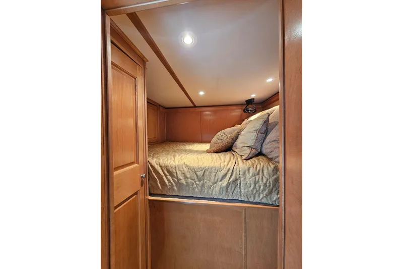 Slide: The Image of Cozy wooden cabin bedroom in 2002 Sharpe 18x85 houseboat with soft lighting. - 41