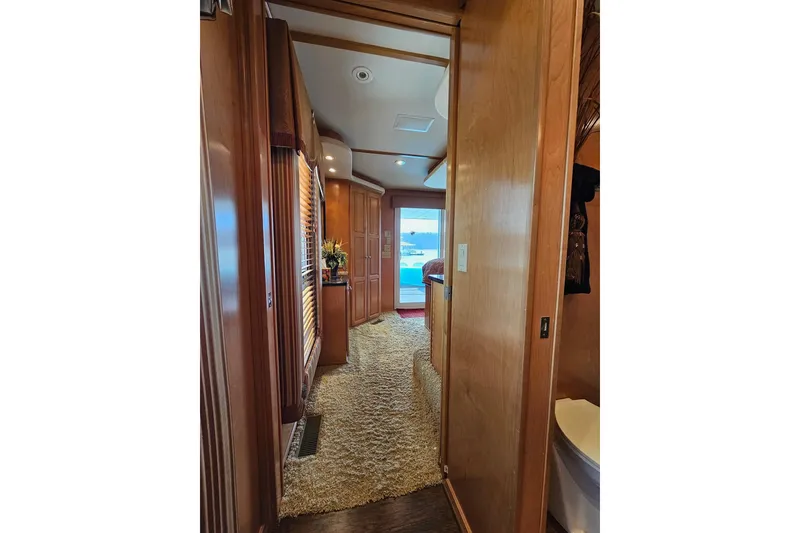 Slide: The Image of Interior hallway of 2002 Sharpe 18x85 houseboat with wood paneling and carpet. - 47