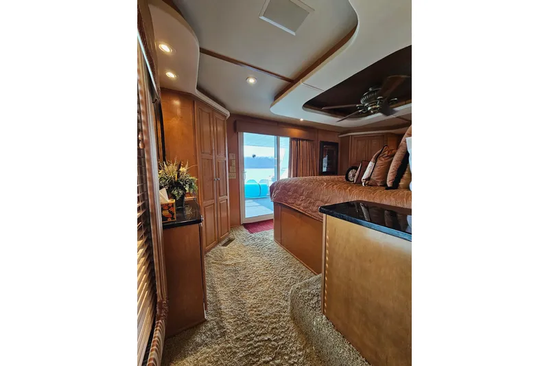Slide: The Image of Luxurious interior of 2002 Sharpe 18x85 houseboat with cozy bedroom and elegant decor. - 48