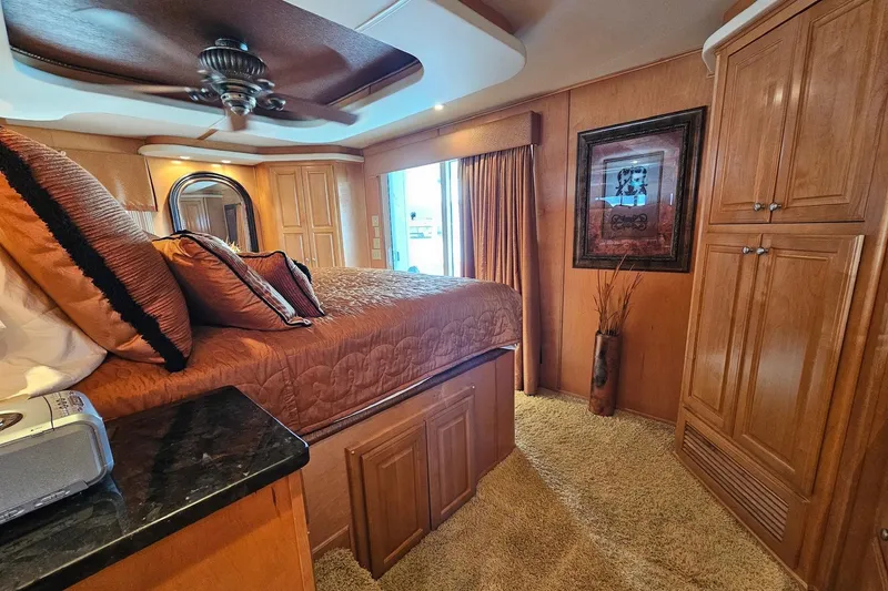 Slide: The Image of Luxurious bedroom in 2002 Sharpe 18x85 houseboat with elegant wood finishes and cozy decor. - 52