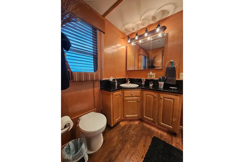 Slide: The Image of Luxurious wooden bathroom interior in 2002 Sharpe 18x85 houseboat, featuring modern fixtures and lighting. - 55