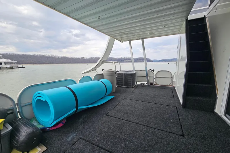 Slide: The Image of Houseboat deck with blue mat, lake view, and stairs; Sharpe 18x85, 2002 model. - 62