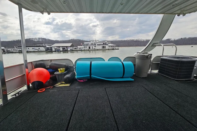 Slide: The Image of Houseboat deck with equipment, overlooking marina and water, Sharpe 18x85, 2002 model. - 64