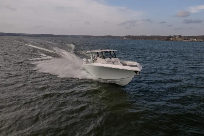 The Image of 2026 Fountain 43 SCX boat cruising on open water under a cloudy sky. - 0