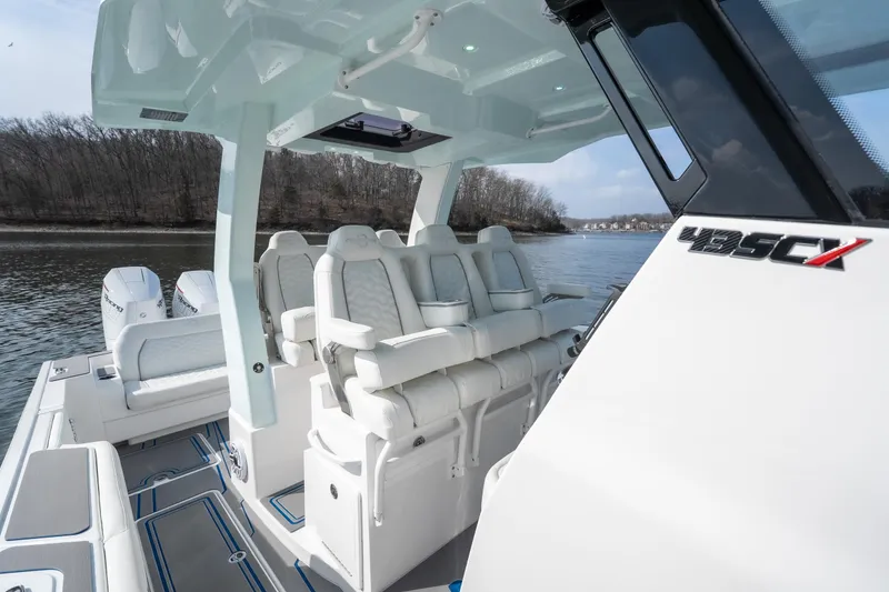 Slide: The Image of 2026 Fountain 43 SCX boat with luxurious seating on a calm river. - 23