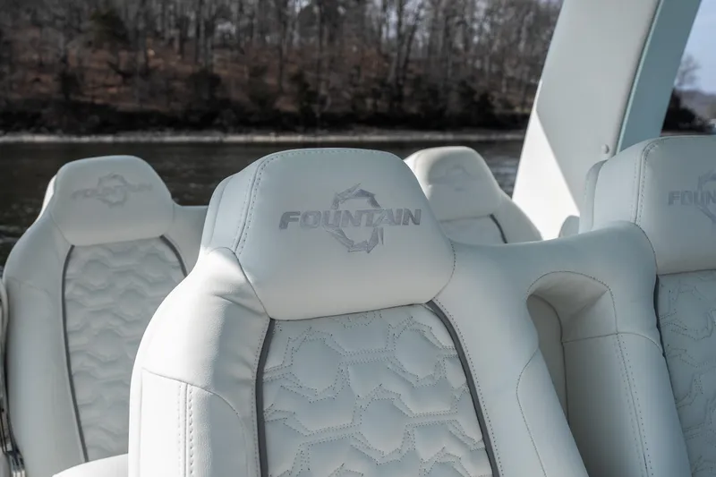 Slide: The Image of Luxurious white seats in 2026 Fountain 43 SCX boat, featuring embossed logo design. - 26