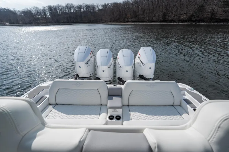 Slide: The Image of 2026 Fountain 43 SCX boat with four powerful outboard motors on a serene lake. - 28