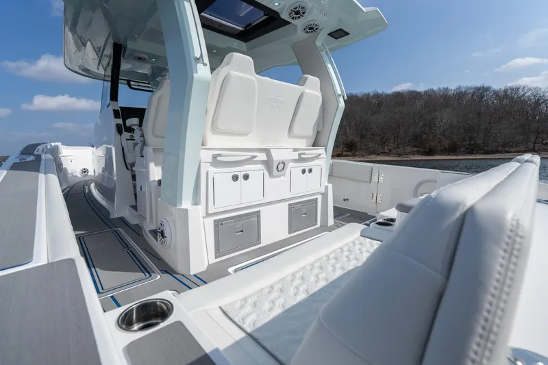 Slide: The Image of 2026 Fountain 43 SCX boat interior with luxurious seating and modern design on a sunny day. - 33
