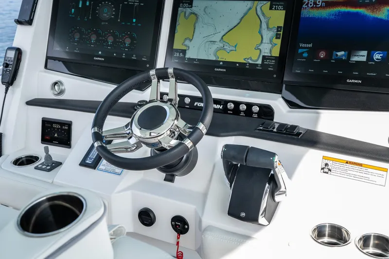 Slide: The Image of 2026 Fountain 43 SCX boat dashboard with advanced Garmin navigation displays and controls. - 37