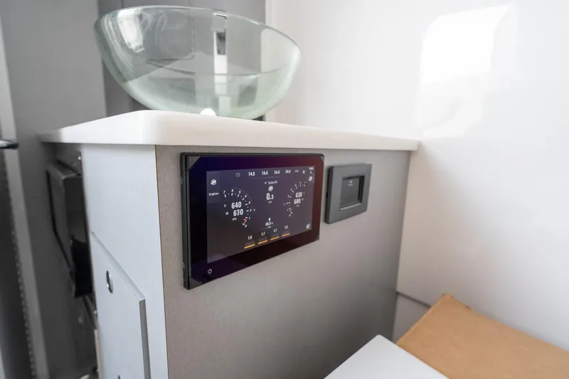 Slide: The Image of 2026 Fountain 43 SCX boat interior with modern control panel and glass sink. - 50