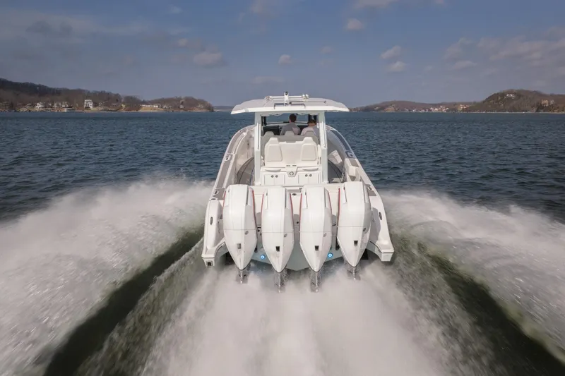 Slide: The Image of 2026 Fountain 43 SCX boat speeding on a lake with four powerful engines. - 54