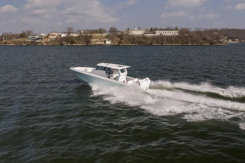 Slide: The Image of 2026 Fountain 43 SCX speedboat cruising on a lake under a partly cloudy sky. - 57