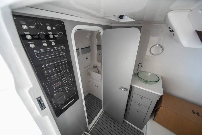 Slide: The Image of Interior of 2026 Fountain 43 SCX boat featuring control panel and modern bathroom amenities. - 9