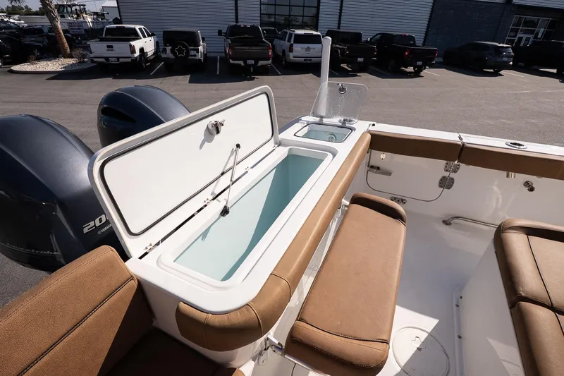 Slide: The Image of 2021 Sea Hunt Gamefish 27 Coffin Box with open storage, brown seating, and dual engines. - 14