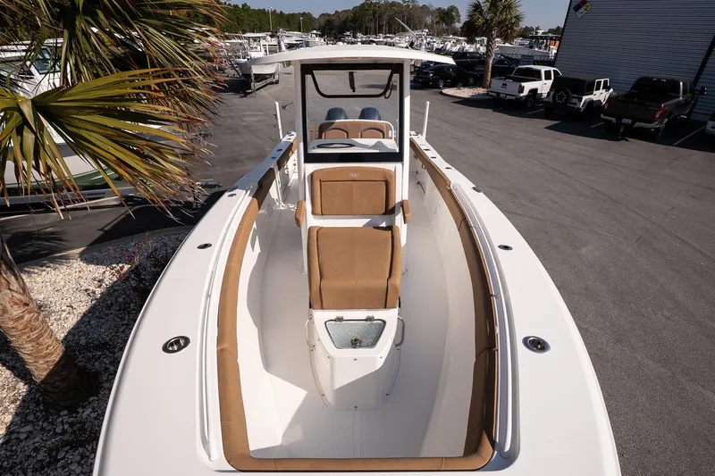 Slide: The Image of 2021 Sea Hunt Gamefish 27 Coffin Box boat with tan seating, docked outdoors. - 15