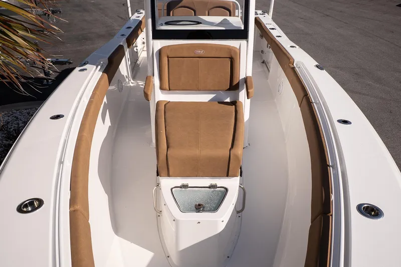 Slide: The Image of 2021 Sea Hunt Gamefish 27 Coffin Box boat interior with tan seating and white deck. - 16