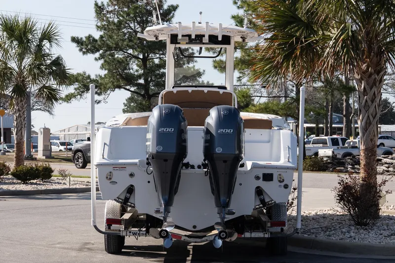 Slide: The Image of 2021 Sea Hunt Gamefish 27 Coffin Box boat with dual Yamaha engines, parked outdoors. - 5