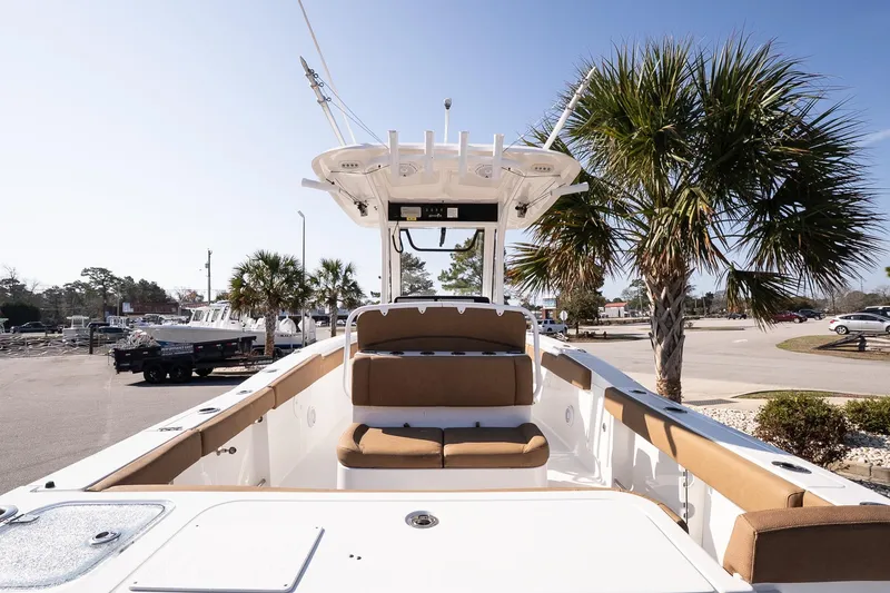 Slide: The Image of 2021 Sea Hunt Gamefish 27 Coffin Box boat with seating, palm trees in background. - 7