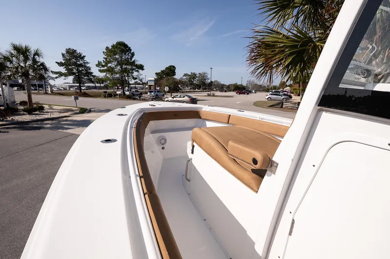 Slide: The Image of 2021 Sea Hunt Gamefish 27 Coffin Box boat with tan seating, parked outdoors. - 9