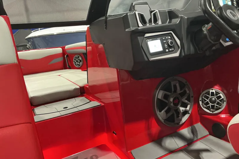 Slide: The Image of 2022 Axis T250 boat interior with red and gray seating, speakers, and control panel. - 10