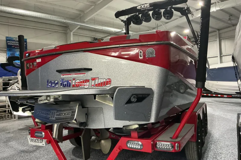 Slide: The Image of 2022 Axis T250 boat in showroom, red and silver design, with "Love You Long Time" text. - 3