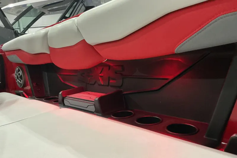 Slide: The Image of 2022 Axis T250 boat interior with red and white seating, cup holders, and speaker. - 7