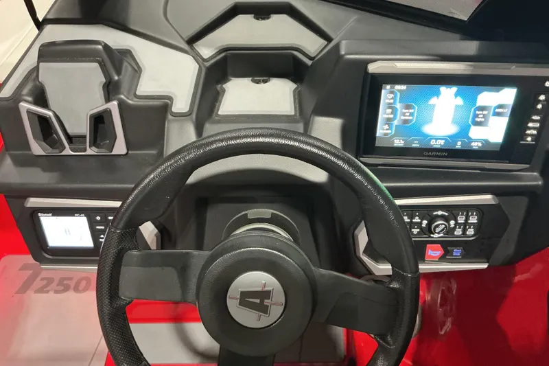 Slide: The Image of 2022 Axis T250 dashboard with steering wheel and Garmin display. - 9