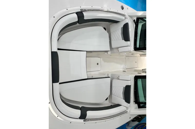 Slide: The Image of 2026 Robalo R277 Dual Console boat interior with white and black seating. - 10