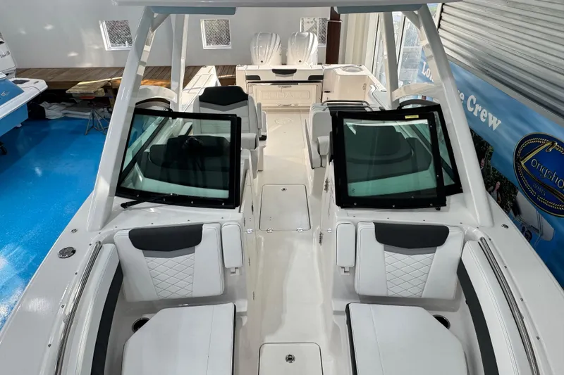 Slide: The Image of 2026 Robalo R277 Dual Console boat interior with modern seating and windshield design. - 11