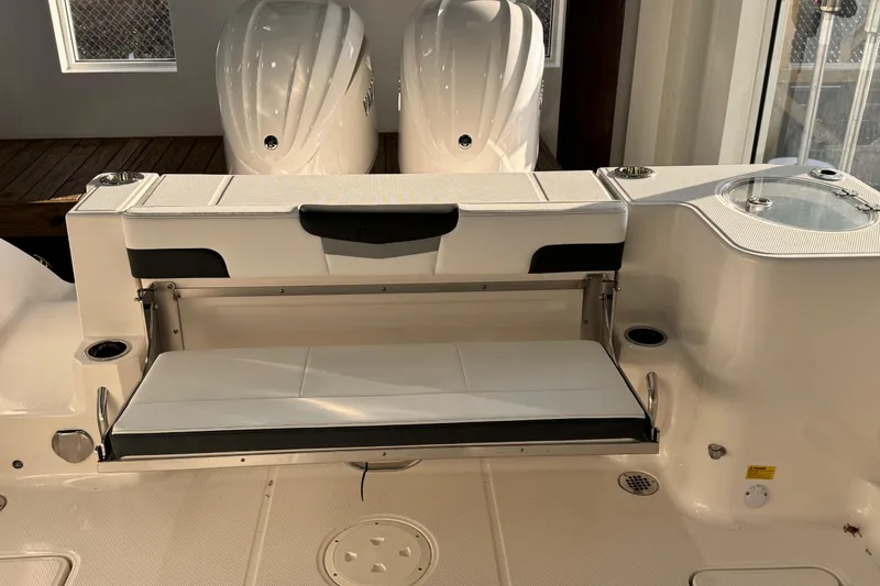 Slide: The Image of 2026 Robalo R277 Dual Console boat interior with seating and twin engines. - 15