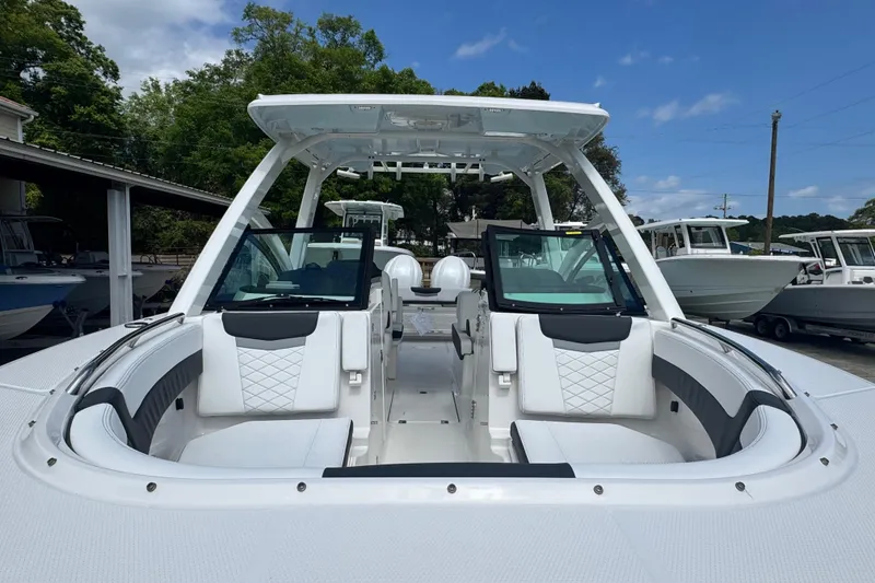 Slide: The Image of 2026 Robalo R277 Dual Console boat with sleek white seating and modern design. - 18