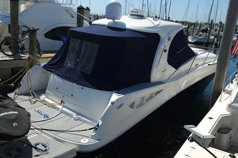 The Image of 2008 Sea Ray 40 Sundancer yacht docked at marina with blue canopy. - 0