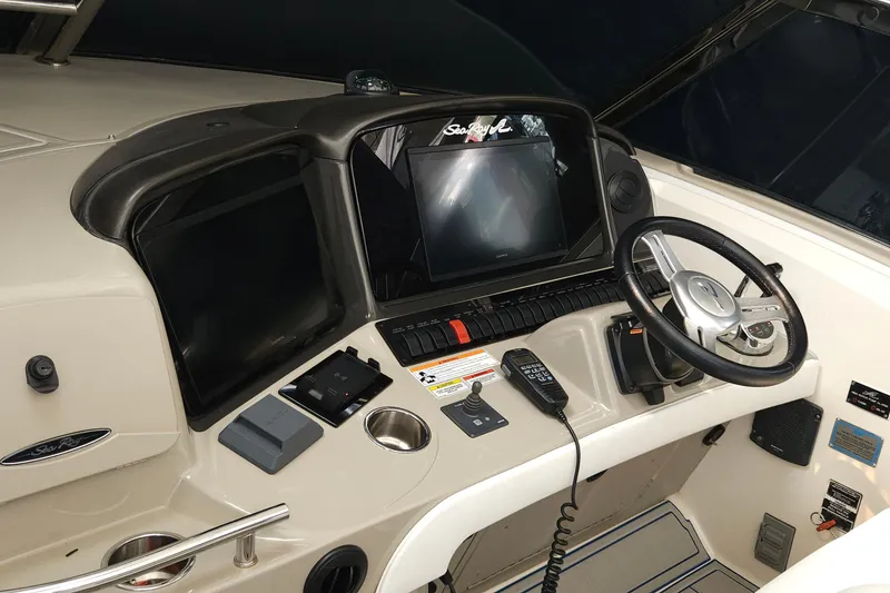 Slide: The Image of Control panel of a 2008 Sea Ray 40 Sundancer boat with steering wheel and navigation screens. - 11