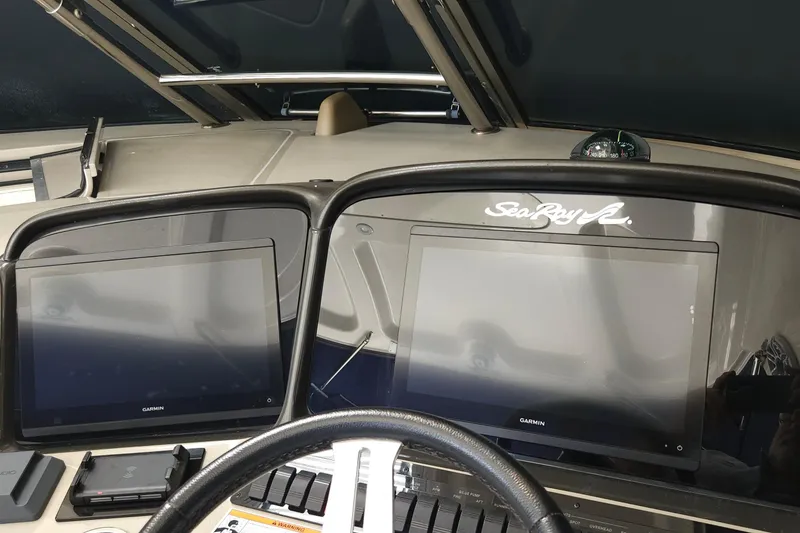 Slide: The Image of 2008 Sea Ray 40 Sundancer helm with dual Garmin displays and compass. - 12