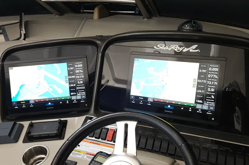Slide: The Image of Dashboard of a 2008 Sea Ray 40 Sundancer with dual Garmin navigation screens. - 14