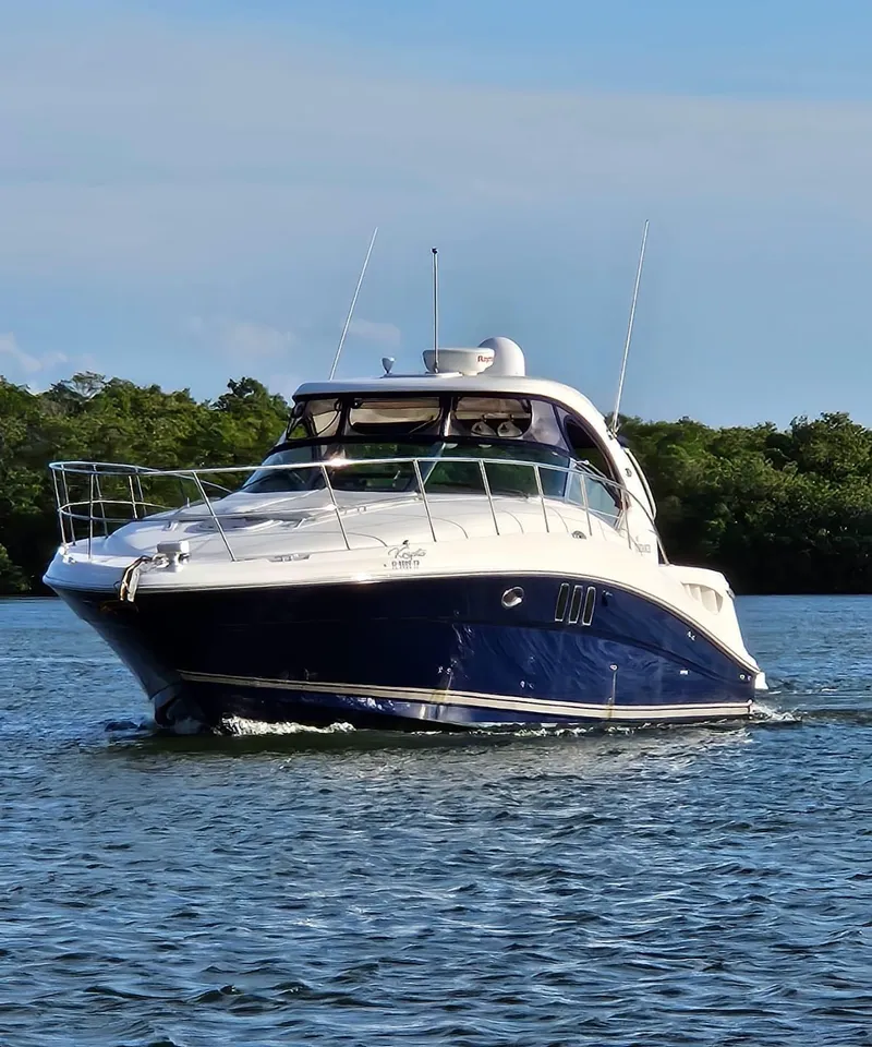 Slide: The Image of 2008 Sea Ray 40 Sundancer yacht cruising on a calm waterway. - 2
