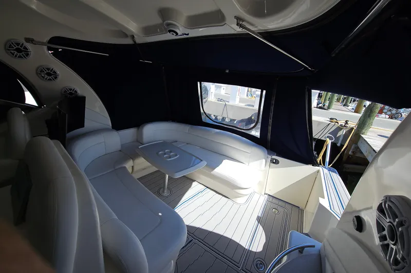 Slide: The Image of 2008 Sea Ray 40 Sundancer interior with white seating and table, docked at marina. - 21