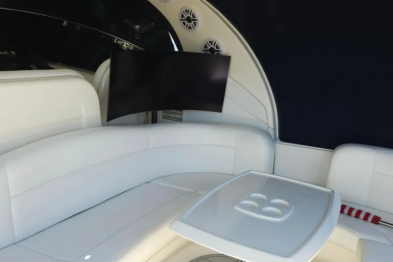 Slide: The Image of Luxurious interior of 2008 Sea Ray 40 Sundancer with white seating and mounted TV. - 23